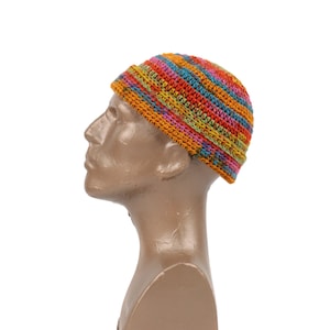 May include: A colourful crocheted beanie hat with stripes of orange, pink, green, and blue.