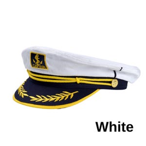 May include: White captain's hat with a navy blue brim and gold accents. The hat features a gold anchor emblem and the word "CAPTAIN" on the front. The brim is decorated with gold leaf-like embroidery and a gold rope detail.