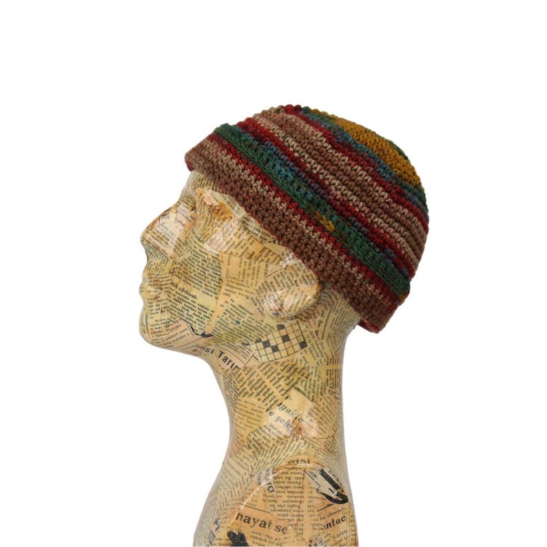 May include: A brown, green, red, and yellow striped crocheted beanie hat.