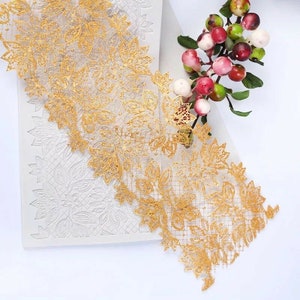 May include: A gold lace trim silicone mould for baking and decorating cakes and other desserts. The mould features a delicate floral design.