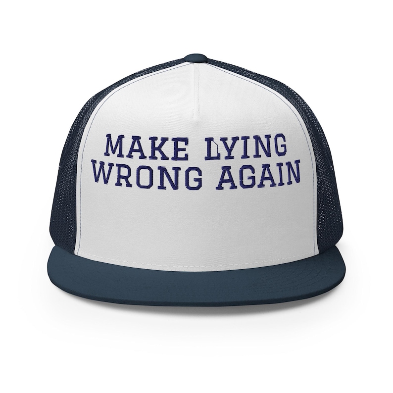 May include: A white and navy blue trucker hat with the text "MAKE LYING WRONG AGAIN" in navy blue.