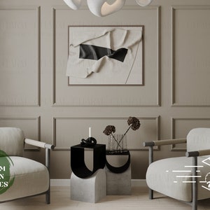 May include: Two beige armchairs with black metal legs and arms, facing each other in a living room setting. A small table with two black and gray abstract sculptures sits between the chairs. A framed abstract art piece hangs on the wall behind the table. The text "FREE CUSTOM DESIGN SERVICES" is visible on the left armchair.