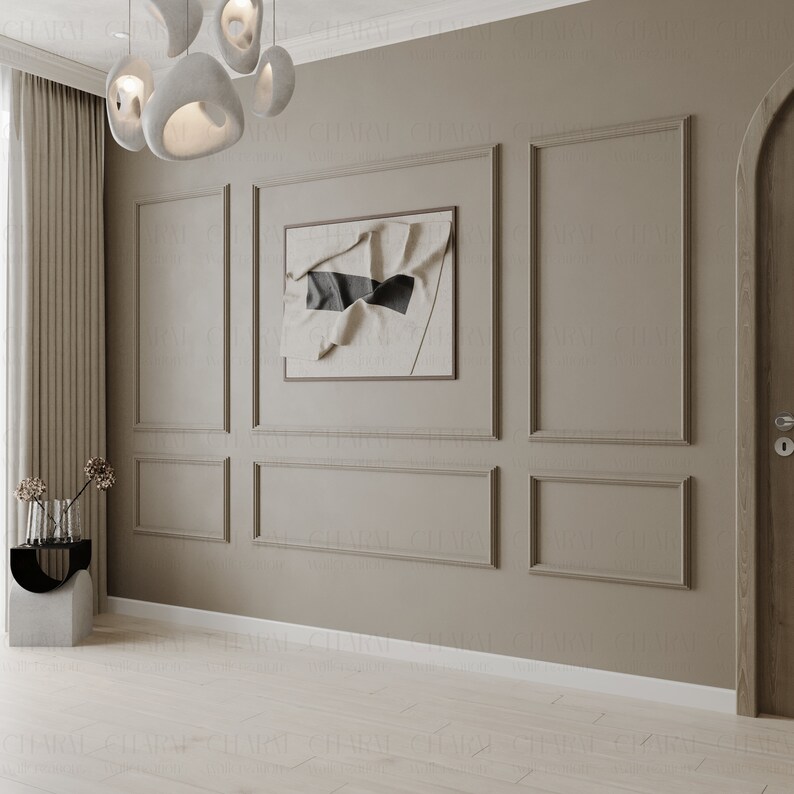 May include: A beige wall with white trim and a framed abstract art print. The wall is divided into sections by the trim, creating a grid pattern. A white door is on the right side of the image.