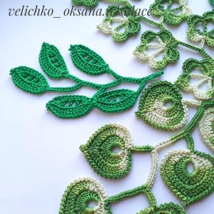 May include: Green and white crocheted lace motifs, including leaves and flowers. The lace is delicate and intricate, with a variety of shapes and sizes. The lace is perfect for adding a touch of elegance to any project.