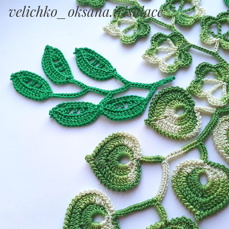 May include: Green and white crocheted lace motifs, including leaves and flowers. The lace is delicate and intricate, with a variety of shapes and sizes. The lace is perfect for adding a touch of elegance to any project.