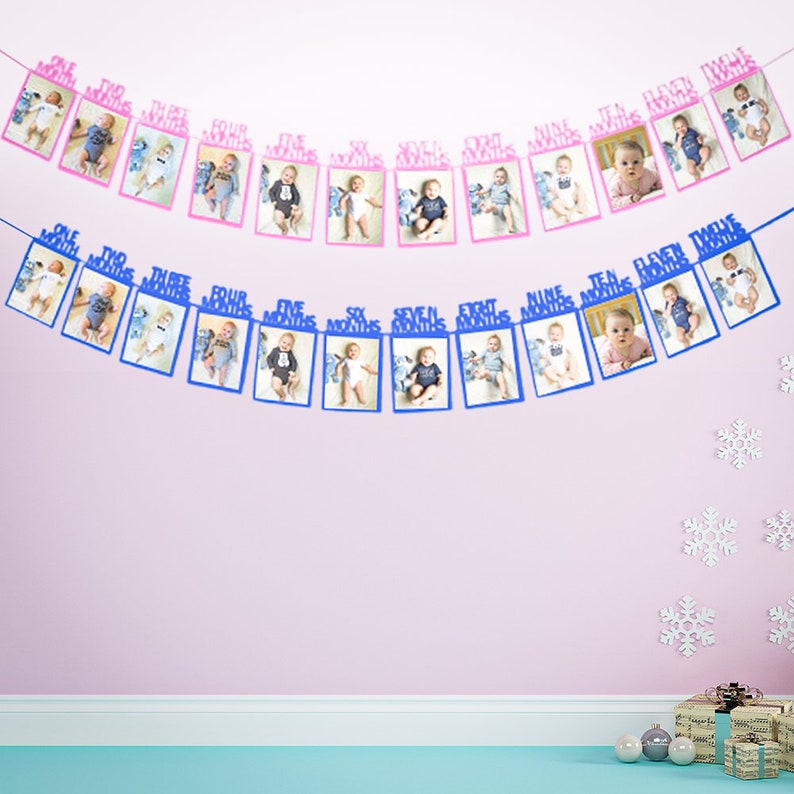 May include: A blue and pink photo banner with 12 frames for pictures. The banner is decorated with blue and pink paper cutouts that say "One Month", "Two Months", "Three Months", etc. The banner is perfect for a baby's first birthday.