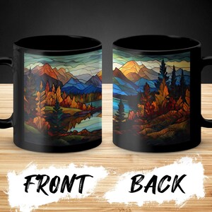 May include: Black ceramic coffee mug with a colorful stained glass style image of a mountain landscape with trees and a lake. The front of the mug shows a close-up of the trees and lake, while the back of the mug shows a wider view of the mountains.