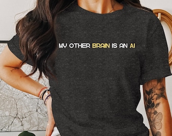 May include: A dark gray t-shirt with the text "MY OTHER BRAIN IS AN AI" in white and yellow lettering.
