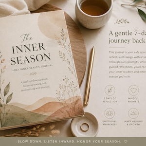 May include: A hardcover journal titled The Inner Season with a beige cover featuring watercolor hills and botanical illustrations. The text reads A gentle 7-day journey back to you, 7 days of reflection, mindful prompts, affirmations to inspire, emotional awareness, inner healing & growth, and nerves system regulation.