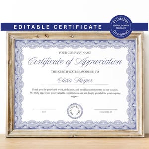 May include: A framed certificate of appreciation with a blue and white design. The certificate includes the text "Certificate of Appreciation" and "Editable Certificate" at the top. The certificate is in a wooden frame.