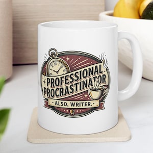 May include: A white ceramic mug featuring a graphic illustration of a pocket watch and a steaming cup of coffee. The text reads "PROFESSIONAL PROCRASTINATOR" and "ALSO, WRITER." The design uses a color palette of maroon, cream, and black.