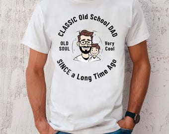 May include: White t-shirt with a black graphic design that says "Classic Old School Dad" with a cartoon image of a father and son. The text also says "Old Soul" and "Very Cool" with the words "Since a Long Time Ago" underneath.