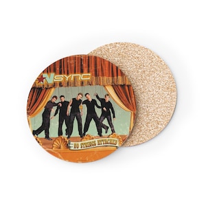 May include: Round coaster featuring a vintage design with the band *NSYNC* on a stage. The coaster has a retro aesthetic with the words "NO STRINGS ATTACHED". The second coaster is made of cork.
