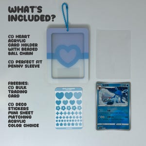 May include: A light blue and white acrylic card holder with a heart cutout and a matching blue beaded ball chain, a clear penny sleeve, a sheet of blue heart and star stickers, and a blue trading card featuring a Glaceon character illustration.