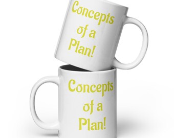 May include: Two white ceramic mugs stacked on top of each other. Each mug has a curved handle and the words "Concepts of a Plan!" printed in yellow. The mugs are likely for coffee or tea.