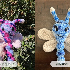 May include: Two crocheted dragonfly plush toys. The left toy features a variegated pink, purple, and blue yarn pattern. The right toy is made of blue and white variegated yarn with solid cream-colored wings. Both have black embroidered eyes and antennae.