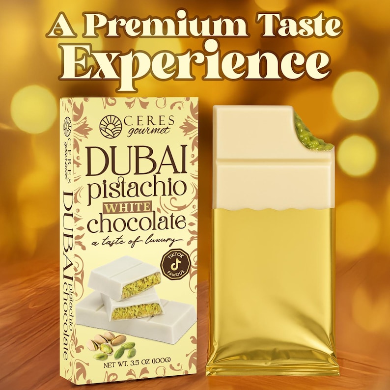 May include: A box and a partially unwrapped white chocolate bar with pistachio filling. The packaging reads "DUBAI pistachio WHITE chocolate" and "A Premium Taste Experience". The bar is 3.5 oz (100g).