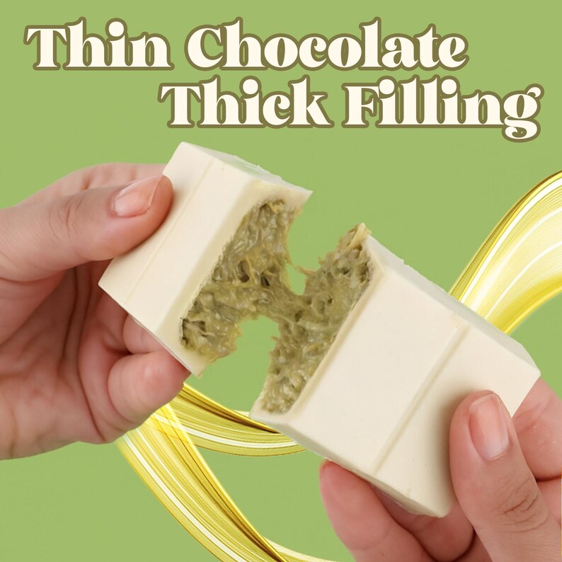 May include: A white chocolate bar broken in half, revealing a thick, green filling. The text "Thin Chocolate Thick Filling" is displayed above the chocolate. The background is a light green with yellow swirls.
