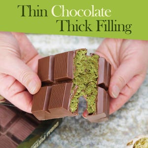 May include: A chocolate bar with a thick, green filling is held by two hands. The bar is broken, revealing the filling. The text "Thin Chocolate Thick Filling" is in the background.