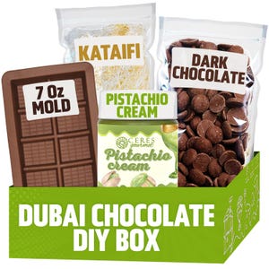 May include: A Dubai Chocolate DIY Box with ingredients for making chocolate. Includes a 7 oz mold, kataifi, pistachio cream, and dark chocolate chips. The box is green with white text that reads "DUBAI CHOCOLATE DIY BOX".