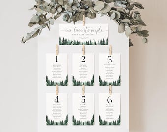 May include: A wedding seating chart with a woodland theme. The chart is made up of six cards with a watercolor forest scene and a number from 1 to 6. Each card lists the names of guests assigned to that table.