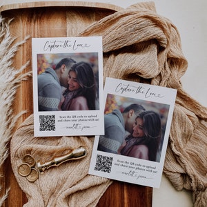 May include: Two white cards with the text "Capture the Love" in black cursive font. Each card features a photo of a couple and a QR code with the text "Scan the QR code to upload and share your photos with us! marlett.joom" in black text.