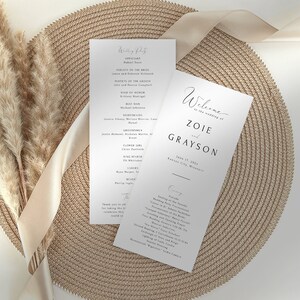 May include: Wedding ceremony programme with a white background and black text. The programme includes the officiant, wedding party, and ceremony details. The programme is titled "Welcome to the wedding of Zoie and Grayson" with the date and location of the wedding.