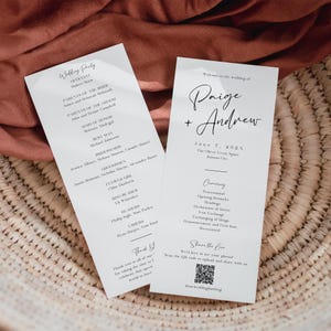 May include: Wedding ceremony program card with the names Paige and Andrew, the date June 7, 2021, and the location The Olive Event Space, Kansas City. The card also includes a list of the wedding party members and the ceremony order.