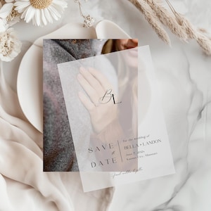 May include: A save the date card with the initials "BL" and the words "SAVE THE DATE" printed in black. The card also includes the wedding details: Bella & Landon, June 7, 202x, Kansas City, Missouri.