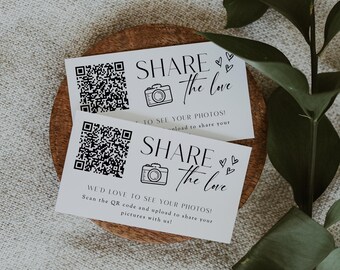 May include: Two white cards with black text and a QR code. The text on the cards reads "Share the love" and "We'd love to see your photos! Scan the QR code and upload to share your pictures with us!"