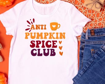 May include: White t-shirt with a graphic design that says "Anti Pumpkin Spice Club" in a colorful font with a coffee cup icon.