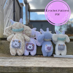 May include: Four crocheted stuffed animals in different colors and patterns. The animals are all wearing overalls with a crocheted flower patch on the back. The animals are sitting on a wooden surface. Crochet Pattern PDF.
