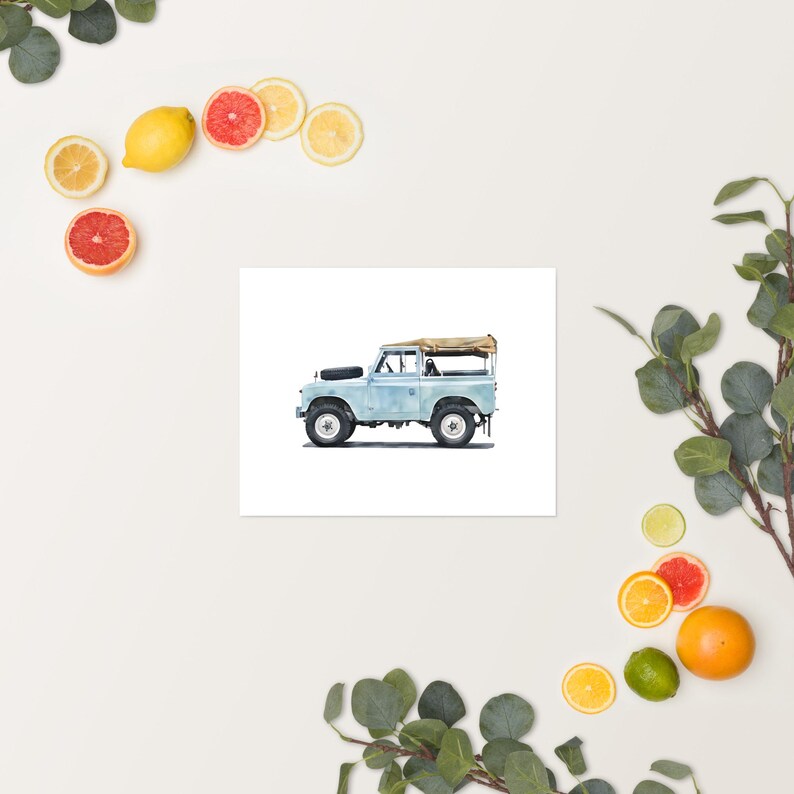 May include: A light blue vintage off-road vehicle illustration with a tan canvas top. The vehicle has black tyres and a spare tyre on the back. The artwork is on a white background, with citrus fruits and greenery around the edges.