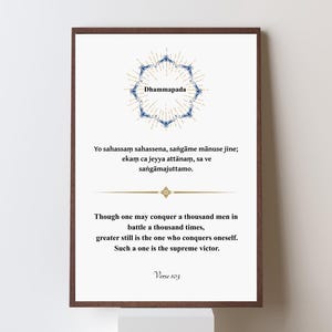 May include: A framed print with a white background and dark brown frame. The print features text and a blue and gold circular design. The text includes the word "Dhammapada" and a quote about self-conquest. Verse 103 is also displayed.