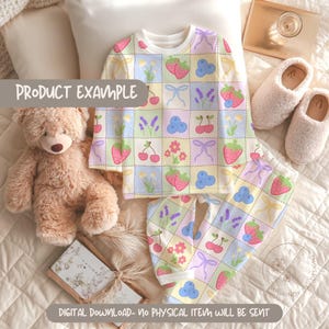 May include: A pastel-colored pajama set with a repeating pattern of strawberries, cherries, bows, and flowers. The long-sleeved top and pants are displayed with a teddy bear, slippers, and a book. Text on the image reads "PRODUCT EXAMPLE" and "DIGITAL DOWNLOAD- NO PHYSICAL ITEM WILL BE SENT".
