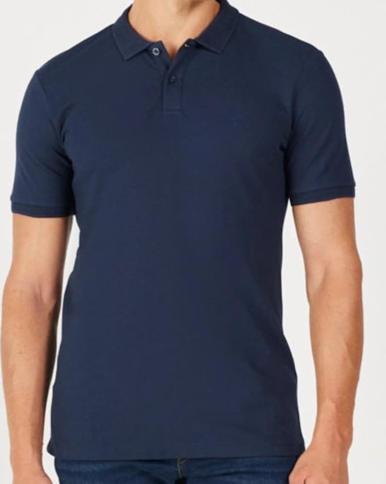 May include: A navy blue polo shirt with short sleeves and a collared neckline. The shirt has a three-button placket and a small logo on the chest. The fabric appears to be a soft, knit material.