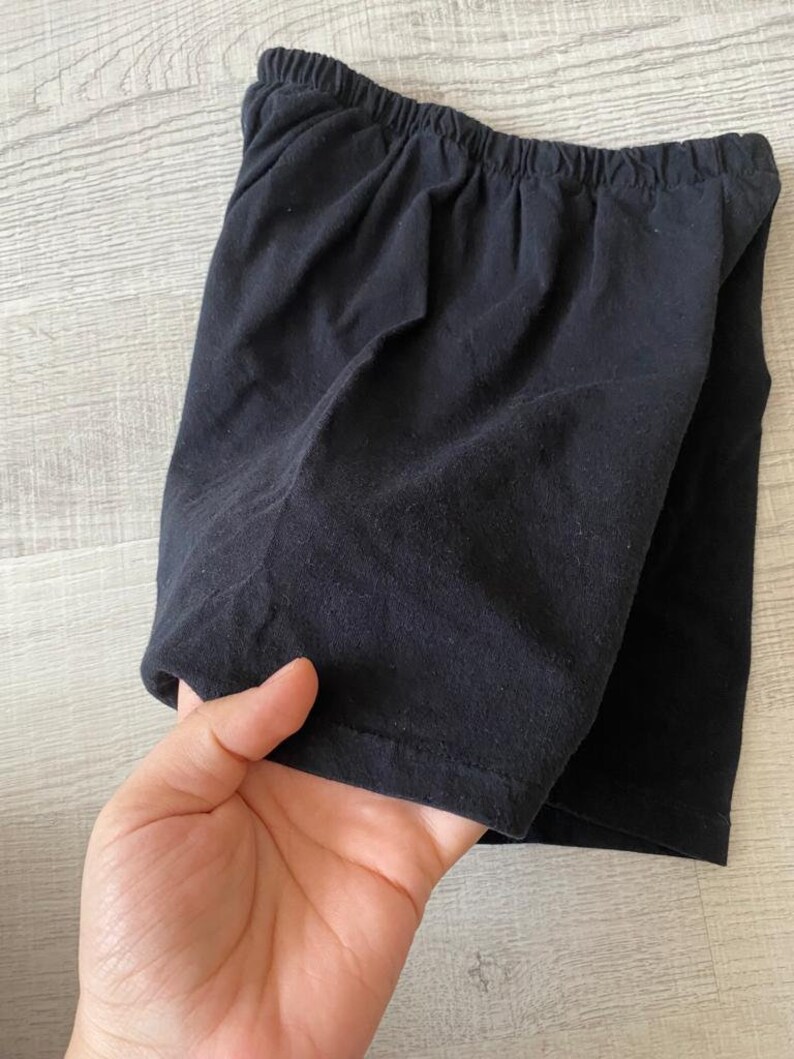 May include: Black cotton shorts with a wide elastic waistband.