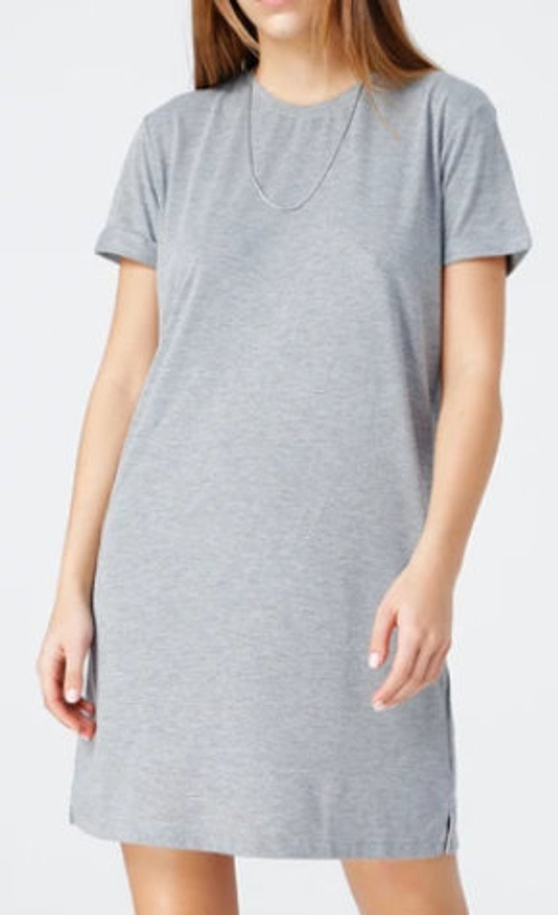 May include: A gray short-sleeved t-shirt dress with a round neckline.