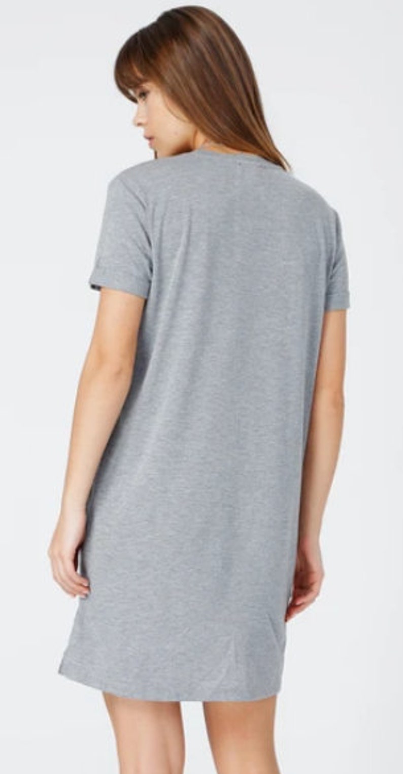 May include: A gray short-sleeved t-shirt dress with a relaxed fit.