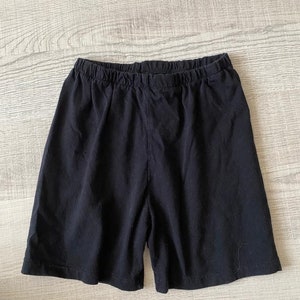 May include: Black cotton shorts with an elastic waistband.