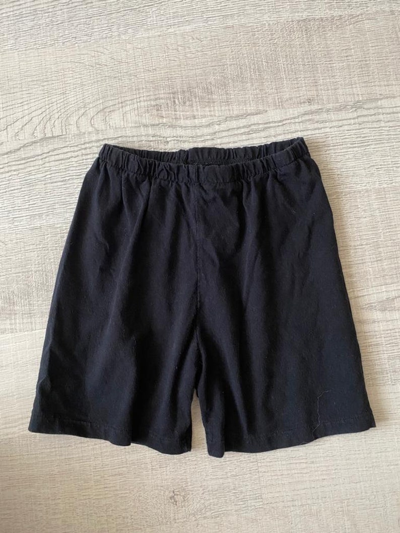 May include: Black cotton shorts with an elastic waistband.