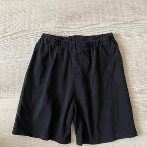 May include: Black cotton shorts with an elastic waistband.