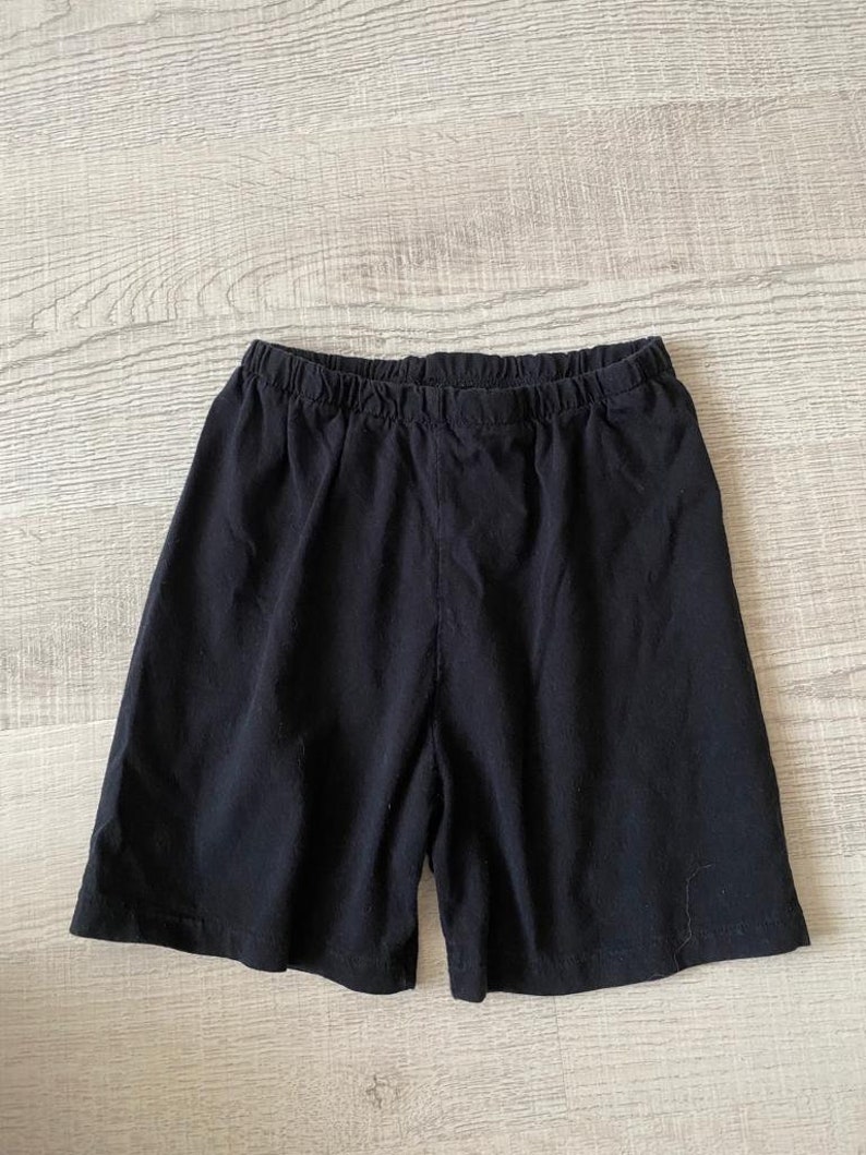 May include: Black cotton shorts with an elastic waistband.