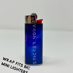 May include: A mini BIC lighter with a blue and purple nebula design. The text "STICKER NOVA" is printed vertically on the lighter. The words "WRAP FITS BIC MINI LIGHTERS" are printed in a diagonal orientation.