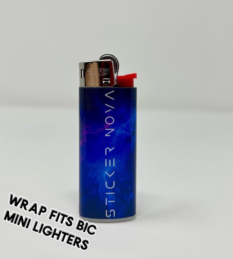 May include: A mini BIC lighter with a blue and purple nebula design. The text "STICKER NOVA" is printed vertically on the lighter. The words "WRAP FITS BIC MINI LIGHTERS" are printed in a diagonal orientation.