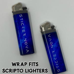 May include: Two blue Scripto lighters with a nebula design and the text "STICKER NOVA". The lighters have a silver top and a gray base. The text "WRAP FITS SCRIPTO LIGHTERS" is at the bottom.