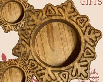May include: Three circular wooden coasters with a carved snowflake design and a central recessed area. The wood has a natural brown grain. The text CHRISTMAS GIFTS is printed in red in the upper right corner, and a red snowflake graphic is below.