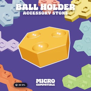 May include: A yellow hexagonal ball holder accessory stone with three circular indentations on the top surface. The text BALL HOLDER ACCESSORY STONE and MICRO COMPATIBLE is visible. The background features various colored geometric shapes.