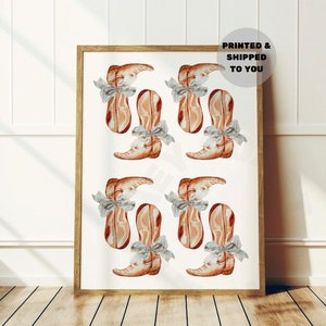 May include: A framed print featuring a repeating pattern of watercolor cowboy boots in shades of brown and tan, each adorned with a gray bow. The text "PRINTED & SHIPPED TO YOU" is visible in the upper right corner.