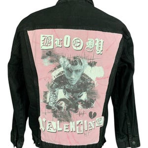 May include: Black denim jacket with a pink back panel featuring a black and white image of a person and the words "BLOOD VALENTINE" in white gothic lettering. The jacket has a classic collar and button closures.